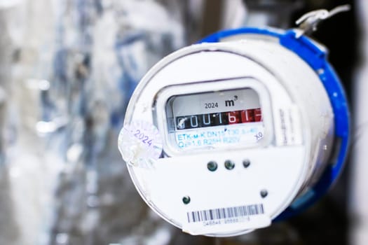 This image showcases a closeup view of a water meter, which displays a reading of 00161, indicating usage measurements for water consumption
