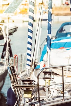 Sailboat deck details with wrapped poles at marina harbor, background, 