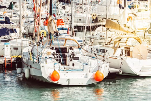 Sailing boats moored in marina during sunny day, nautical theme, 