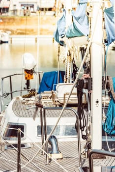 Sailboat docked in marina with detailed view of deck and rigging, background, 