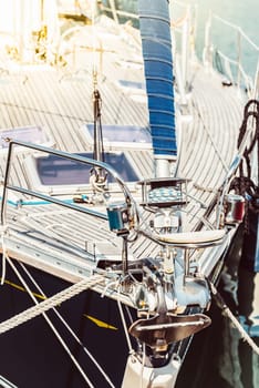 Sailboat deck with focus on rigging and sunlight reflection, background, 