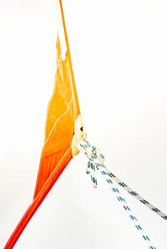 Sailing boat ropes tied to an orange sail, abstract composition, background, 