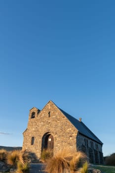 Sun sets on stone front of Church of Good Sheppard in Tekapo., Canterbury New Zealand.