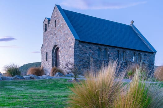 Historic Church of Good Sheppard famous tourist destination on shore of Lake Tekapo at twilight in New Zealand.
