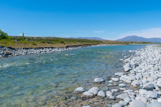 Tekapo River flowing over stony river bed in Canterbury New Zealand.