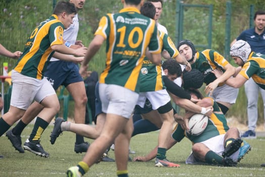 3 may 2025, lisbon. Portugal - oeiras vs ag - rugby players running and tackling during a rugby game, fighting for the ball
