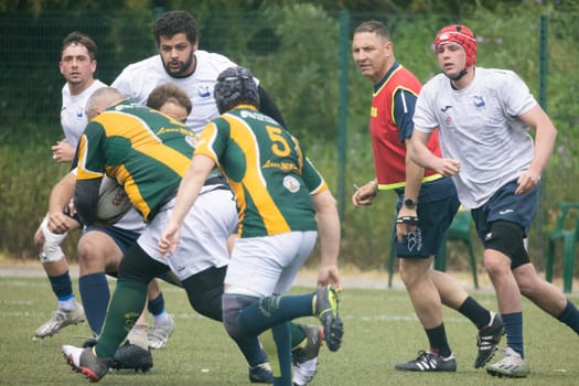 3 may 2025, lisbon. Portugal - oeiras vs ag - rugby players running and competing during a match, with the referee watching the action