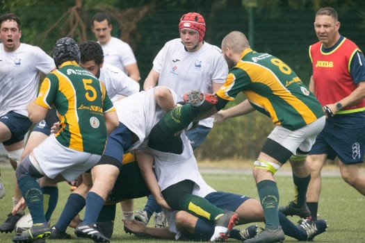 3 may 2025, lisbon. Portugal - oeiras vs ag - rugby players wearing team uniforms are tackling and competing for the ball during a rugby match