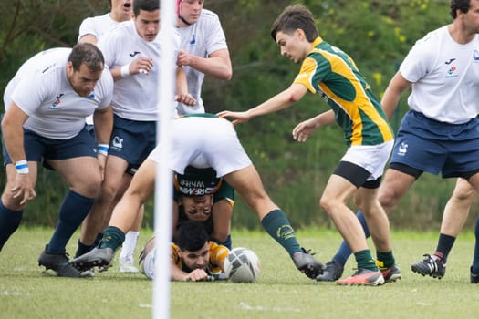 3 may 2025, lisbon. Portugal - oeiras vs ag - rugby players competing for the ball during a rugby match, forming a ruck