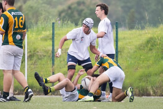 3 may 2025, lisbon. Portugal - oeiras vs ag - rugby players competing for the ball during a match on a green field
