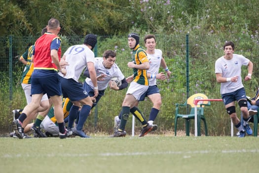 3 may 2025, lisbon. Portugal - oeiras vs ag - rugby players competing for the ball during a game on a green field
