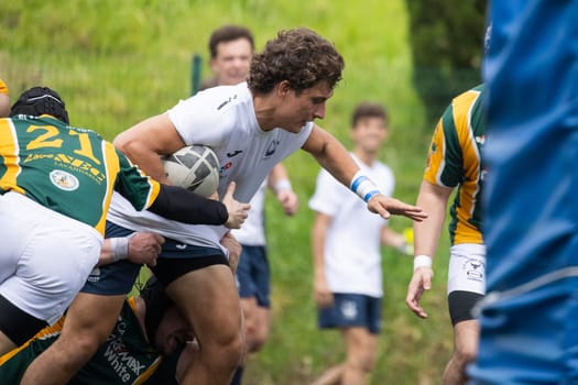 3 may 2025, lisbon. Portugal - oeiras vs ag - rugby player carrying the ball and reaching out during a rugby match