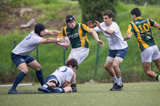 3 may 2025, lisbon. Portugal - oeiras vs ag - rugby players running and tackling during a rugby match on a green field
