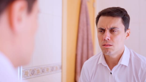 Office worker feeling unwell and suffering from physical discomfort in the bathroom