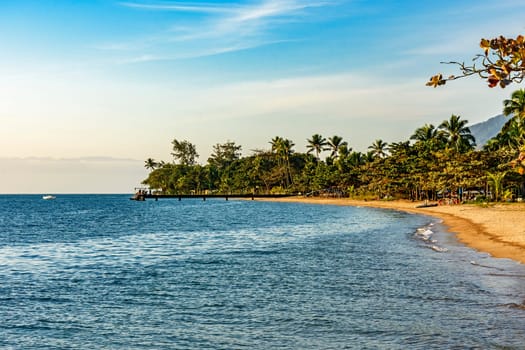 Late afternoon on the beach in the urban area of ​​Ilhabela island during sunset