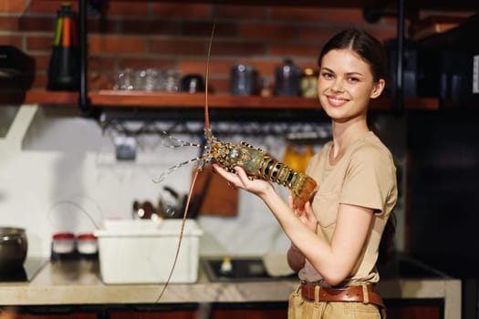 Woman holding lobster in kitchen with bright natural light and modern design interior