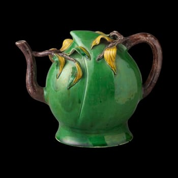 Elegant, antique Chinese porcelain tea pot shaped like a peach with delicate branch and leaf details. Rich green glaze with brown accents. Symbol of longevity and prosperity.