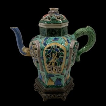 Antique Chinese wine pot, early 18th century, featuring Famille Verte enamels on a hexagonal form with dragon handle and spout. Rich in historical and artistic detail.