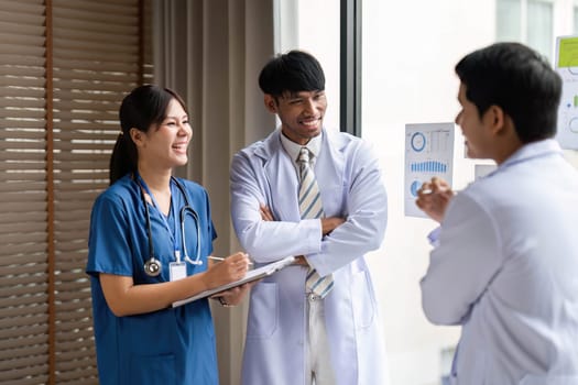 Healthcare workers engaging in positive interaction while discussing insights on patient data analytics for better healthcare outcomes.