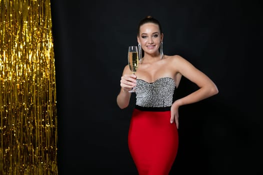 Woman in an evening cocktail party with a glass of wine for the holiday