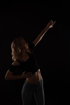 Slender blonde woman dancing alone to bachata music