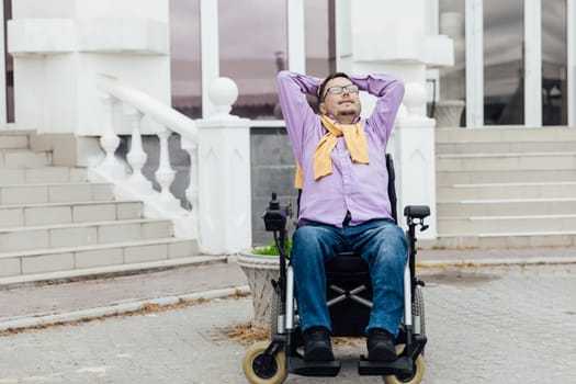 A man in a wheelchair is resting on a walk through the streets