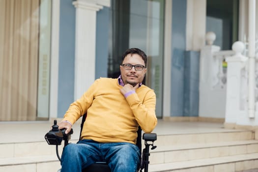 A man in a wheelchair is resting on a walk through the streets