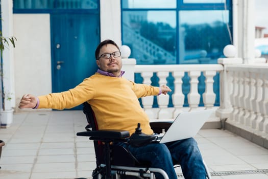A man in a wheelchair is resting on a walk through the streets
