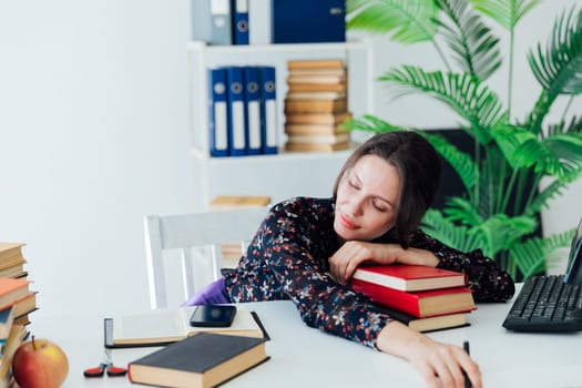 Woman in business suit fell asleep at desk in office tired