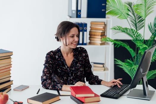 Woman in business suit smiling working at desk in office training