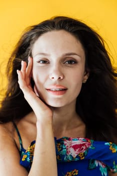 Portrait of Beautiful Slim Fashion Woman in Summer Blue Dress with Flowers on Yellow Background
