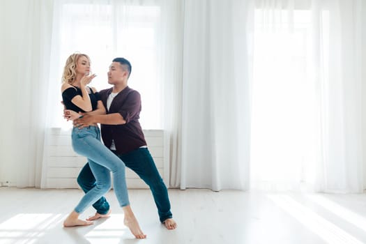 Man and woman dancing together to bachata music