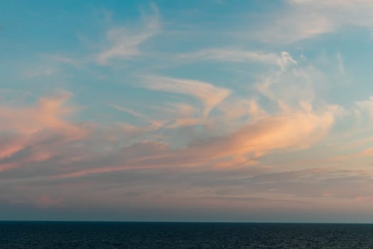 Beautiful landscape, blue sea and sunset sky with clouds on the horizon