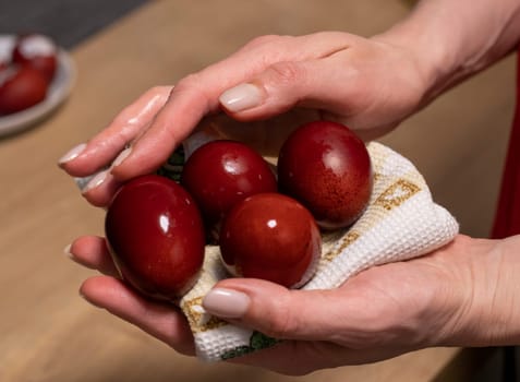 Woman holds Easter eggs just colored with onion peel