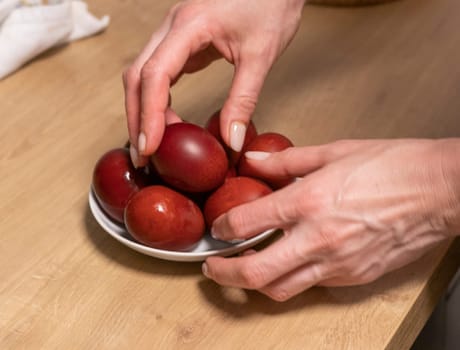 Woman holds Easter eggs just colored with onion peel