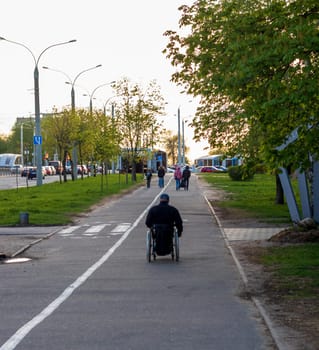 Shot of the handicapped man on the wheelchair on the city streets
