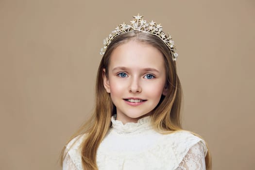 A charming portrait of a smiling young girl wearing a beautiful crown and lace dress, set on a soft beige background This image captures innocence and joy, ideal for children s fashion or beauty themes