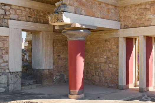 The iconic red columns and stone structures of Knossos Palace stand as a testament to Minoan civilization. The vibrant architecture highlights the grandeur of ancient Crete.