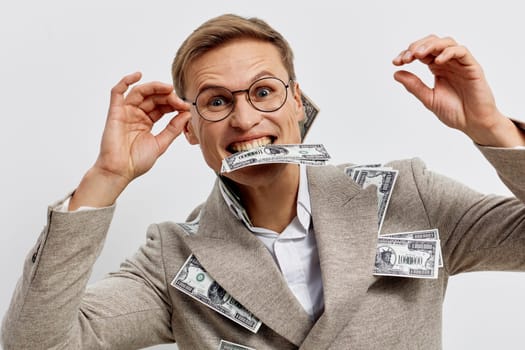 Happy woman wearing glasses and a suit, holding dollar bills in a playful manner, expressing excitement about money, isolated on plain light background, lively and cheerful mood, finance, success, business, humor concept
