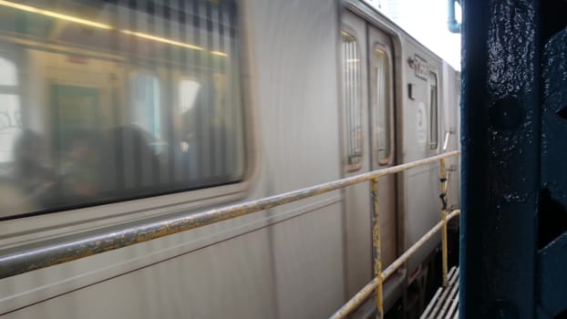 New York City, United States - 29 August 2023: Subway station. Metro train on public transportation platform. Elevated outdoor Court Square railway, Queens. NYC passenger railroad traffic, Long Island