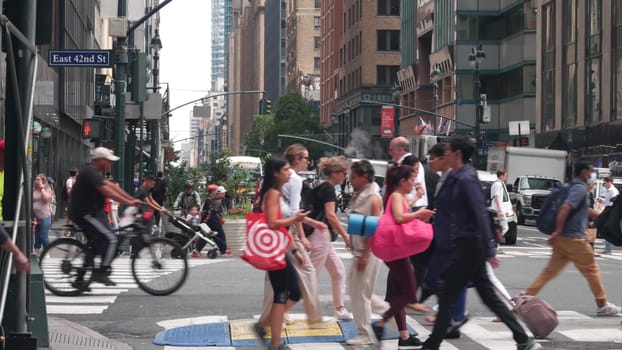 New York City, United States - 29 Aug 2023: Manhattan Midtown East 42 street, Lexington Lex avenue crossroad intersection. Urban road car traffic in USA. People, pedestrians on zebra.