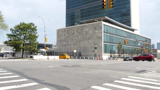 New York City, United States - 4 Sept 2023: United Nations UN Headquarters, Manhattan Midtown, USA. Diplomatic political international organization, General Assembly. Street traffic, yellow taxi car.