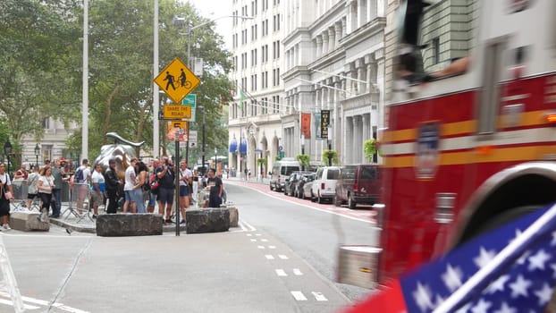New York City, United States - 9 Sept 2023: NYFD car, USA fire department truck, american firefighters vehicle or fire fighter engine, Broadway, Manhattan Downtown financial district. Charging Bull.