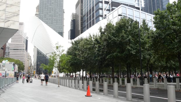 New York City, United States - 10 Sept 2023: Manhattan Downtown Financial District. People near World Trade Center Oculus. Memorial pools and 911 Museum area, Fulton street architecture in USA. Trees.