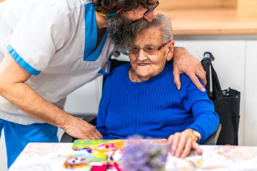 Male nurse kissing elderly patient on forehead, demonstrating love and care in retirement home environment
