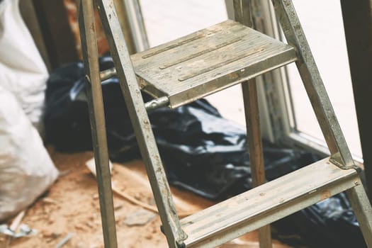 a short folding ladder with flat steps and a small platform