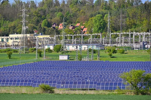 Electric power poles. Power plant - current distribution station. Concept for industry and technology with electricity.
Solar power plant -  ecological industry. Photovoltaic power plant.