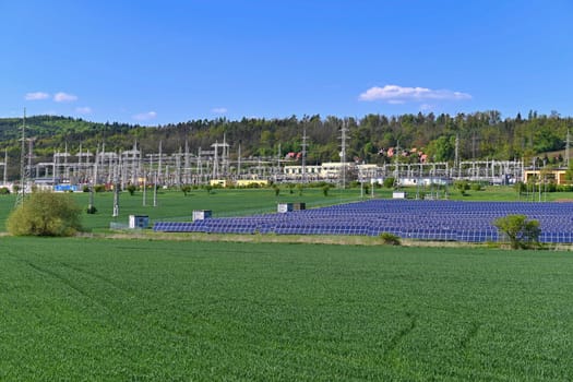Electric power poles. Power plant - current distribution station. Concept for industry and technology with electricity.
Solar power plant -  ecological industry. Photovoltaic power plant.