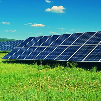 Solar power plant - concept for electricity and ecological industry. High energy prices. Beautiful landscape and sunny day with blue sky. Photovoltaic power plant.