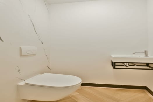 A sleek, modern bathroom featuring clean lines, a minimalist toilet, and a stylish sink. The neutral colors and elegant design create a serene atmosphere.